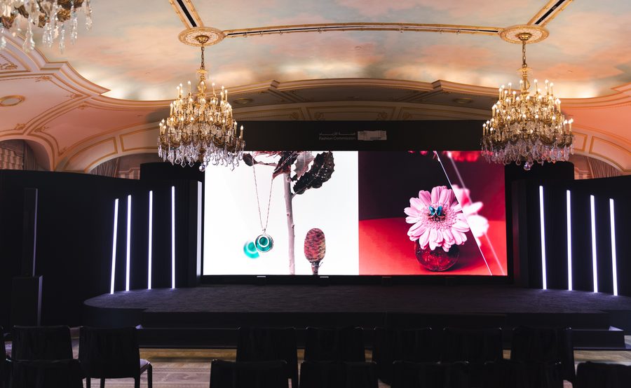 Ballroom stage with a large screen showing jewelry imagery